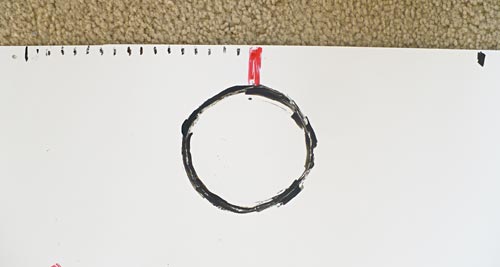 Top-down view of the basket and backboard drawn at the edge of a poster board