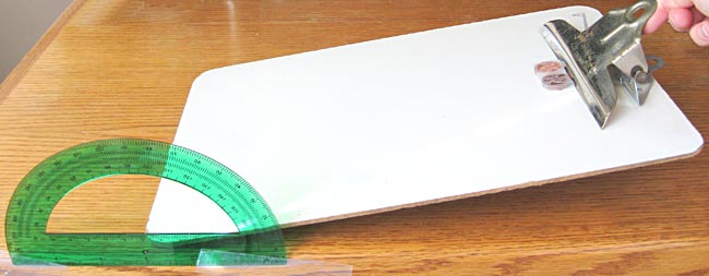 Clipboard tilted slightly showing how to measure the angle on the protractor.