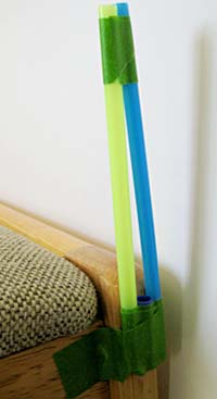 Bridge tower made of straws taped to a chair.