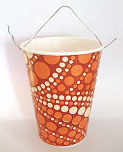 A paper cup with a paperclip attached to the top.