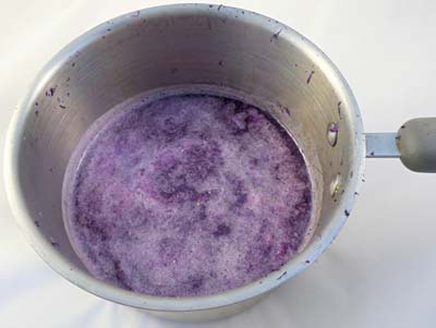 Grated purple cabbage soaking in a pot of boiling water