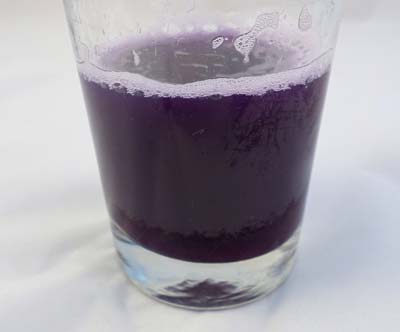 Homemade pH indicator solution made from purple cabbage.