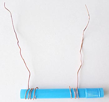 Blue straw connected to copper wire to make a sensor.