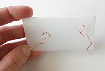 Styrofoam with bent copper wire.