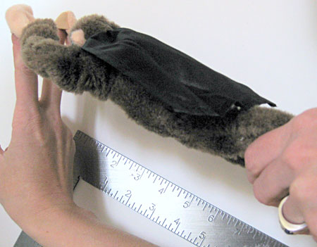 A flying, screaming monkey held parallel to a carpenter's square, unstretched.
