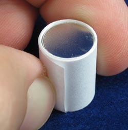 A strip of paper is wrapped around a stack of circular magnets