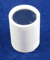 Two strips of paper are wrapped around a stack of circular magnets