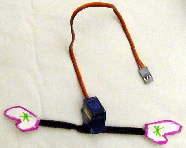 Attaching servo motor to snowman art using pipe cleaner