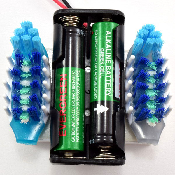 Toothbrushes attached to breadboard