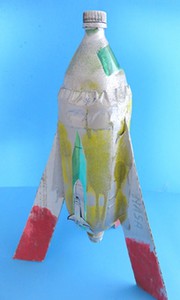  Water bottle rocket with three carboard fins glued to its sides.