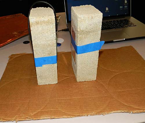 An RFID tag and reader are taped to two bricks facing each other with a small space separating both