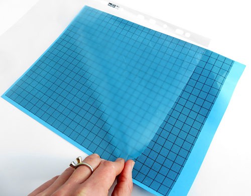 Blue graph paper is placed into a sheet protector