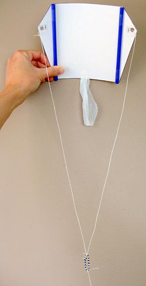 Homemade sled kite built using paper, two straws, a paperclip and string