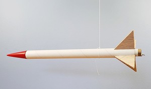  A model rocket balanced while hanging from a string. 