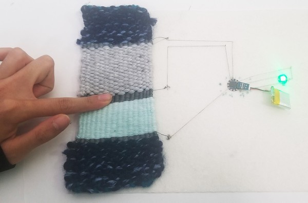 Completed woven sensor patch with LED. 