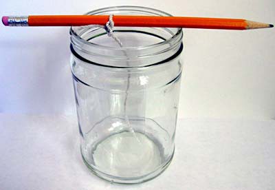 A string is tied around a pencil and the pencil is placed over the mouth of a glass jar