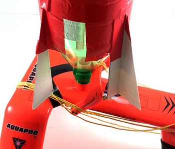 A bottle rocket placed on the bottle rocket launcher so the fins do not hinder the release latch. 