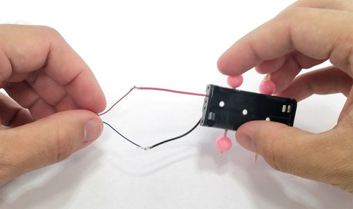 motor and battery wires connected to form a circuit 