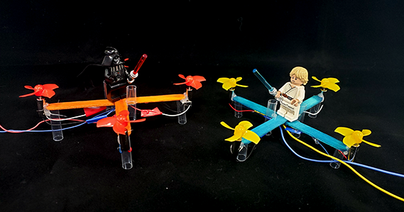 Two popsicle stick drones with Luke and Darth Vader minifigs on top