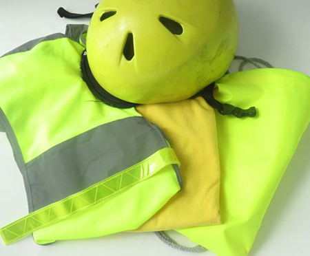 Bright yellow shirts, helmet and safety vest equipped with retro-reflective stripes