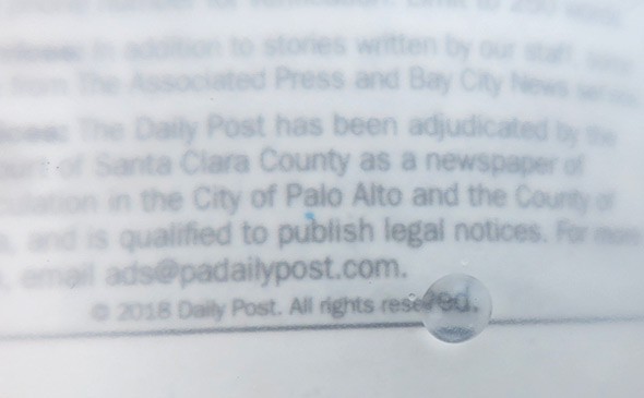 A drop of water magnifies texts on a page