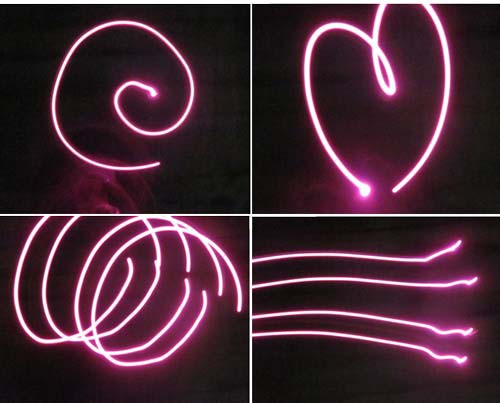 Four photos of a spirals, lines and a heart drawn in the air with LED gloves in a dark room