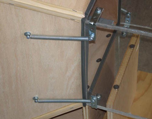 Metal springs hold a Plexiglas box to the back of a contraction cone