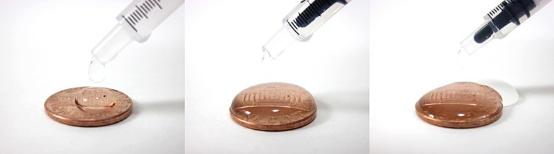 Three photos show water droplets added to the surface of a penny until the water spills over the edge