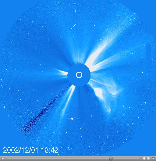 A coronagraph shows a large white flare emerging from the surface of the Sun with a timestamp of 2002/12/01 18:42