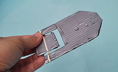 Rubber band paddle boat made from cardboard and duct tape. 