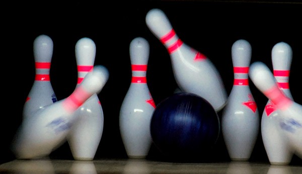 bowling ball striking pins 