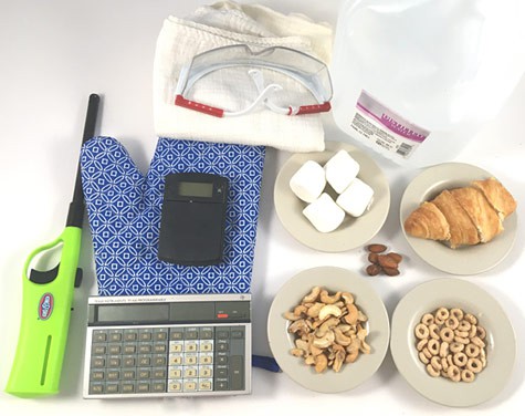 Cashews, pecans, marshmallows, a croissant, cereal, grill lighter, scale, calculator, safety glasses, oven mitt and towel