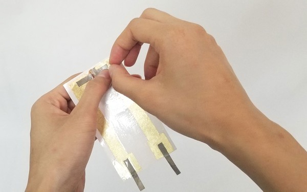Peeling off the plastic film from the corner. 