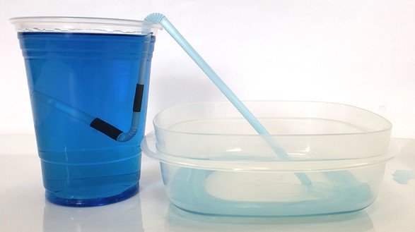 The self-starting siphon when water has just started flowing through the straw. 