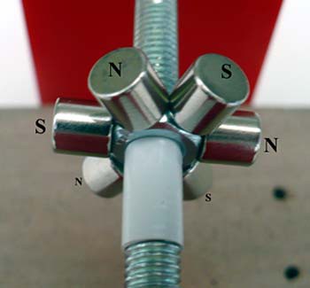 Six cylindrical neodymium magnets are placed on the sides of a hex nut with the outward facing magnetic poles alternating