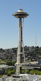 the space needle, a tall skinny tower with a hollow frame and circular observation deck at the top