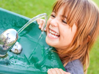 girl drinking from fountain