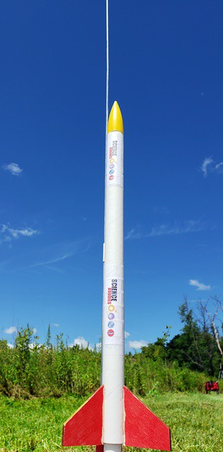  A model rocket on the launch pad ready for launch.  