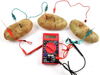 Three potatoes each with zinc and copper electrodes are wired in series with a multimeter