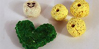 A heart and four balls molded from small lumps of plastic
