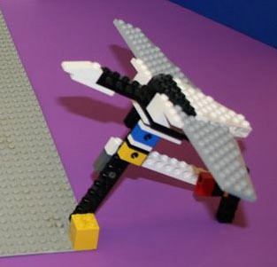A bird in flight is modelled using LEGO pieces and attached to a hinge on the ground