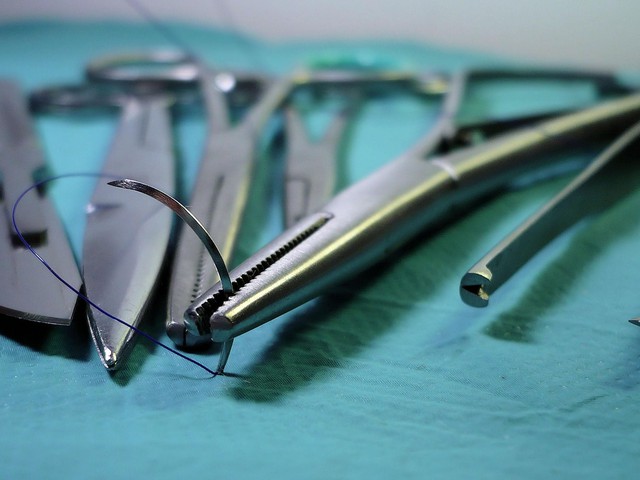 Sterilized surgical tools arranged on a blue hospital cloth.