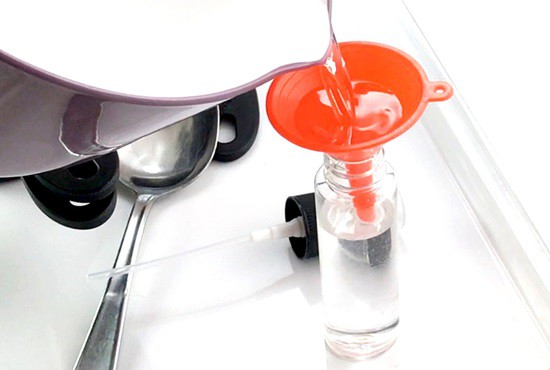 A funnel helps transfer the solution to the bottle