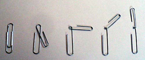 A paperclip is carefully bent inward to create two hooked sides