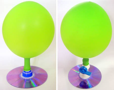 Two homemade hovercrafts made from an inflated balloon, CD and either a bottle cap or a valve