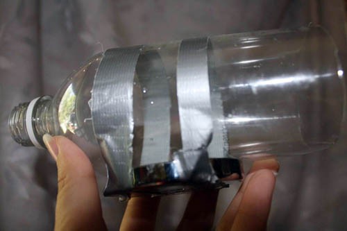 A magnet taped to the side of a plastic bottle