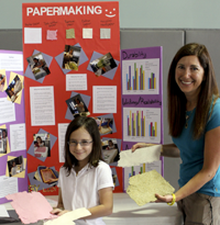 Teacher Lisa Ranja with student and science fair project display board