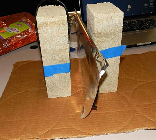 A sheet of aluminum foil is placed between an RFID tag and an RFID reader which are both taped to bricks