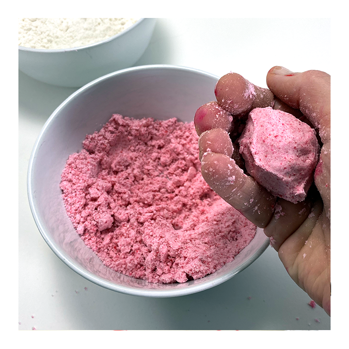 Hand holding kinetic dough formed into a ball - Awesome Summer Science Experiments