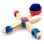 A catapult made from popsicle sticks, rubber bands, and a plastic bottle cap